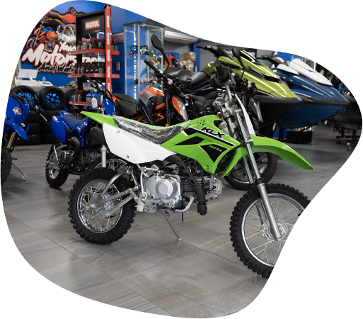 Motora Kawasaki KLX® verde en exhibición dentro del showroom.